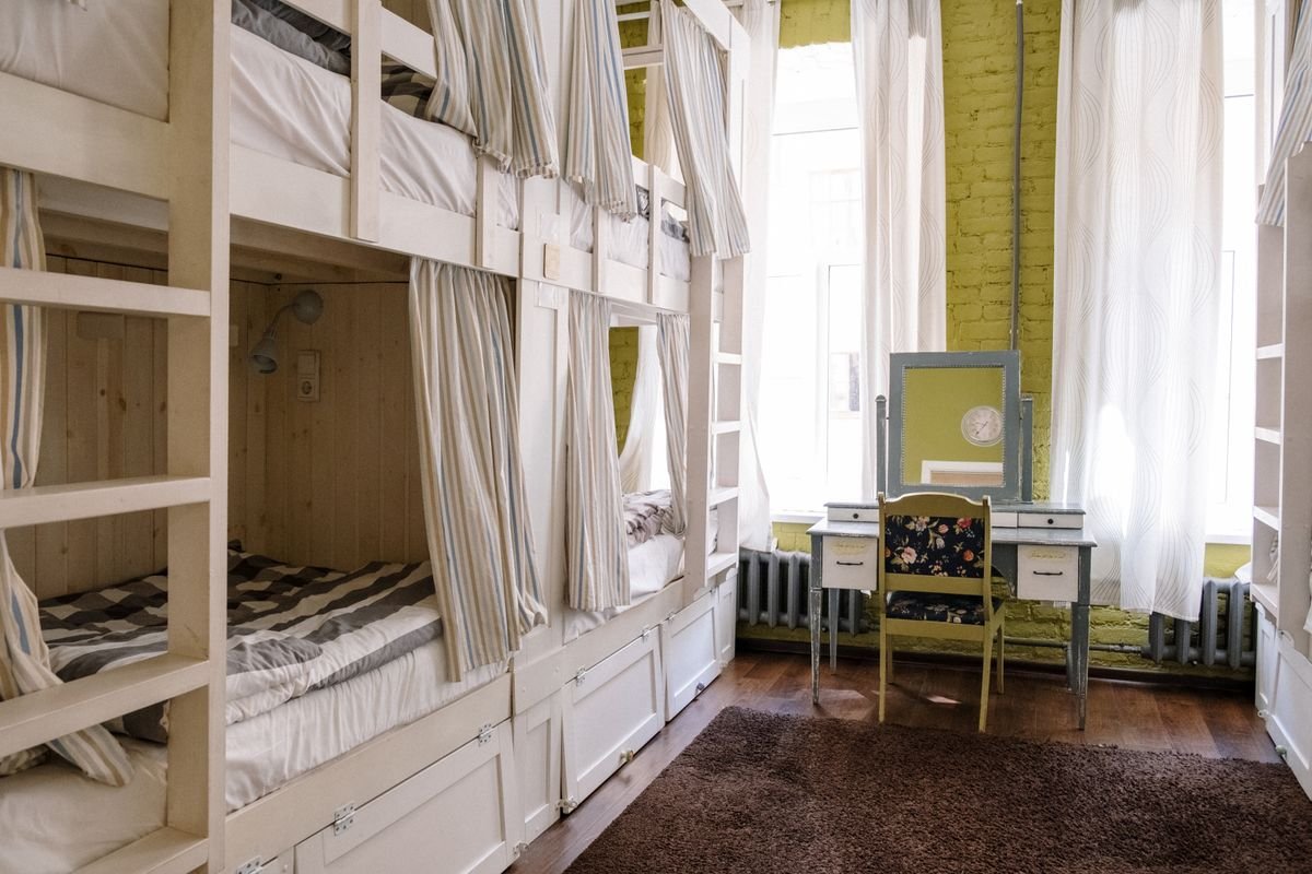A clean shared accommodation room with private bunk spaces